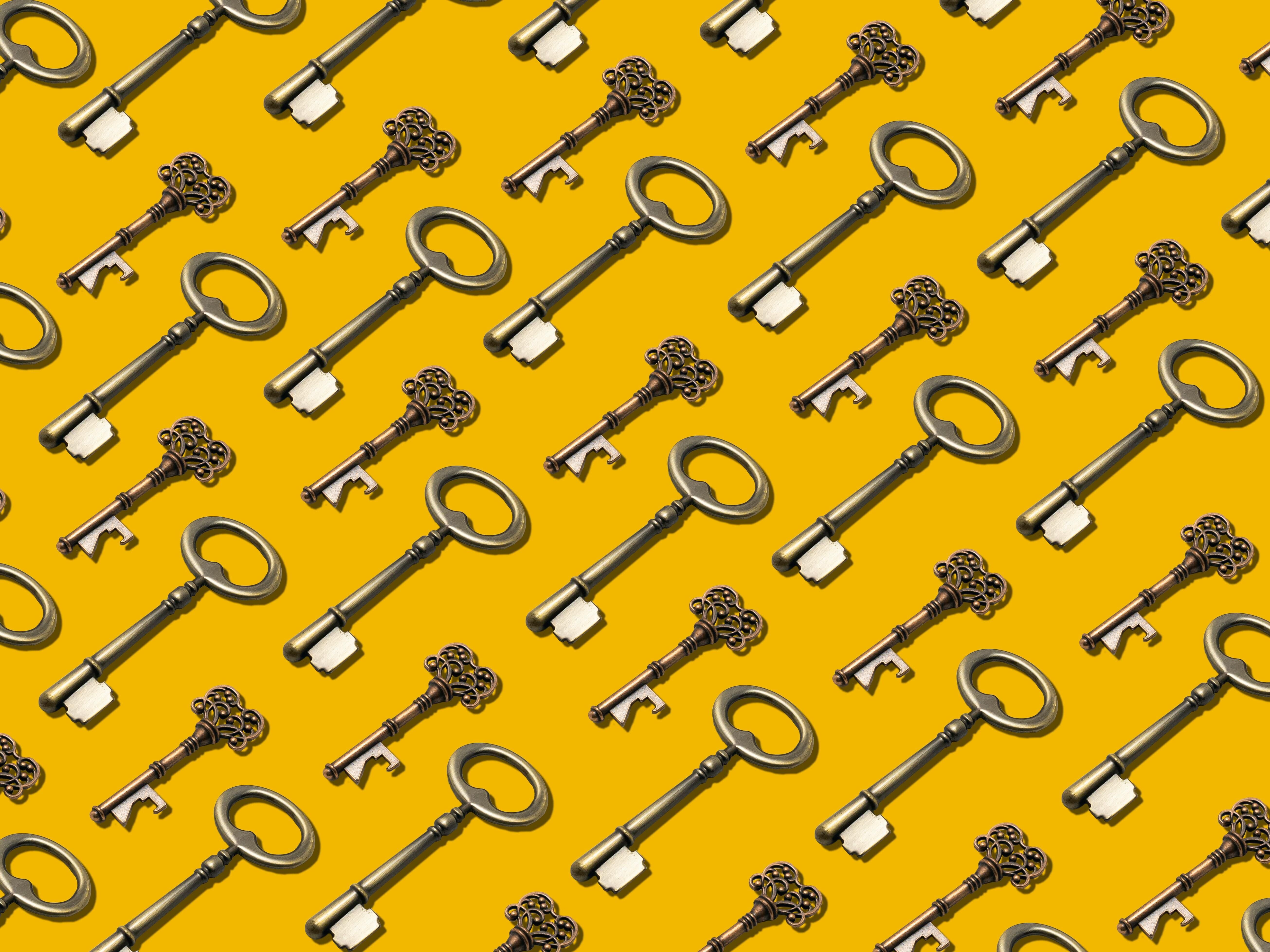 Graphic of repeating old-fashioned keys laid out diagonally against a bright yellow background